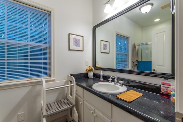 full bathroom featuring a shower stall and vanity