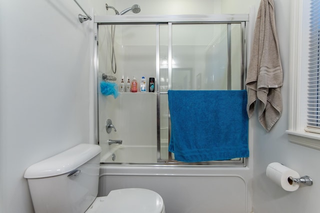 bathroom featuring toilet and enclosed tub / shower combo