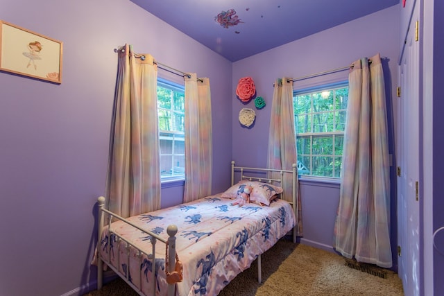 carpeted bedroom with visible vents and baseboards