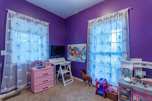 recreation room featuring baseboards, visible vents, and light colored carpet