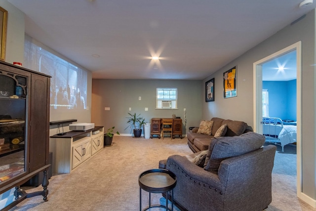 living area featuring light carpet and baseboards