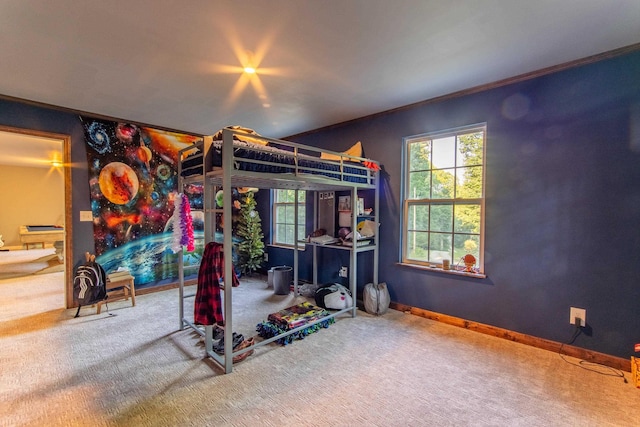 carpeted bedroom with baseboards and crown molding