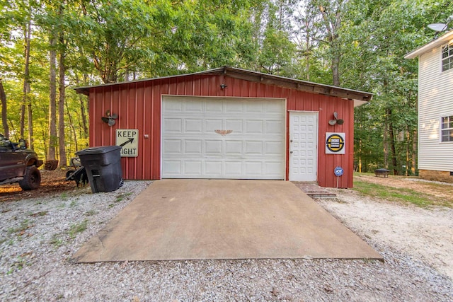 detached garage with gravel driveway