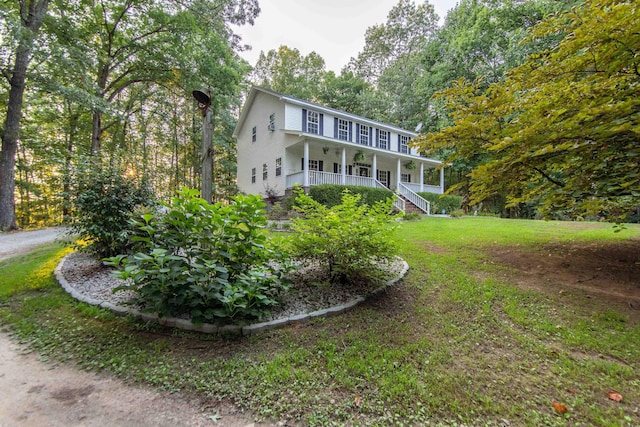 view of front of house with a porch and a front yard