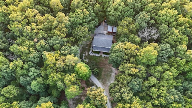 birds eye view of property featuring a view of trees