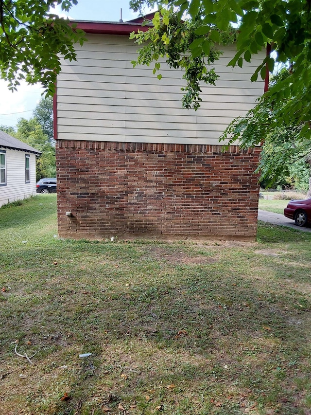 view of property exterior featuring a lawn