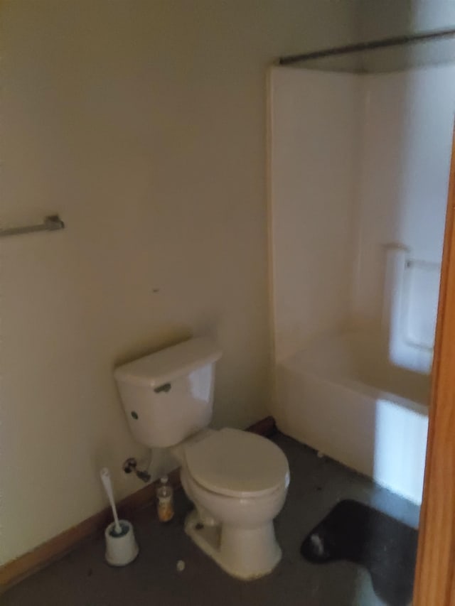 bathroom featuring washtub / shower combination and toilet