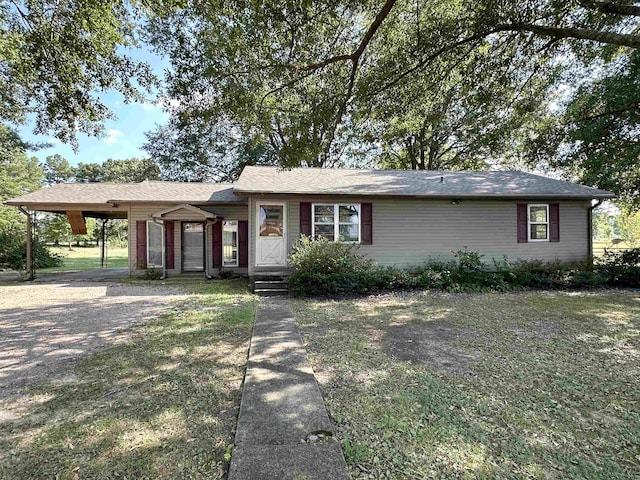 ranch-style house featuring a carport