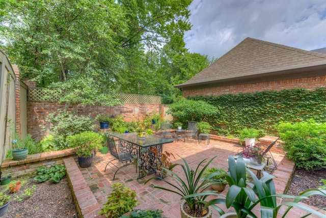 view of patio with a fenced backyard and outdoor dining space