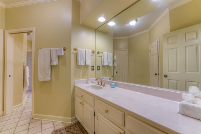 bathroom featuring tile patterned flooring, vanity, ornamental molding, and baseboards