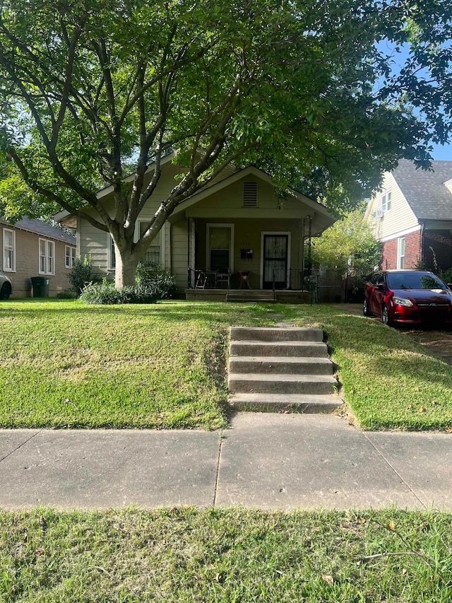 bungalow featuring a front lawn and covered porch