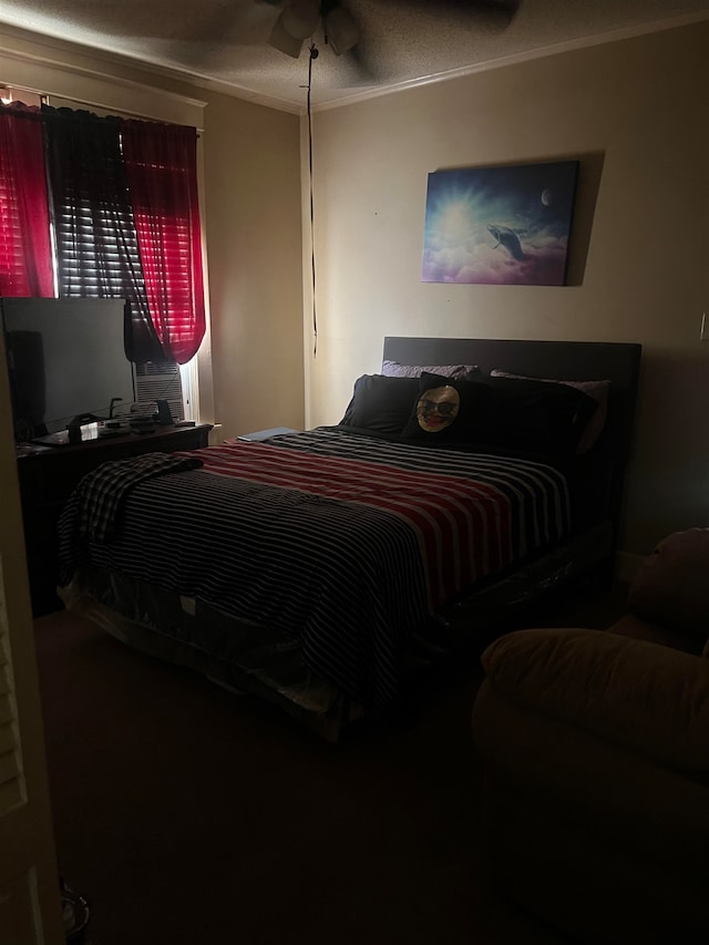 bedroom featuring ceiling fan, a textured ceiling, and crown molding