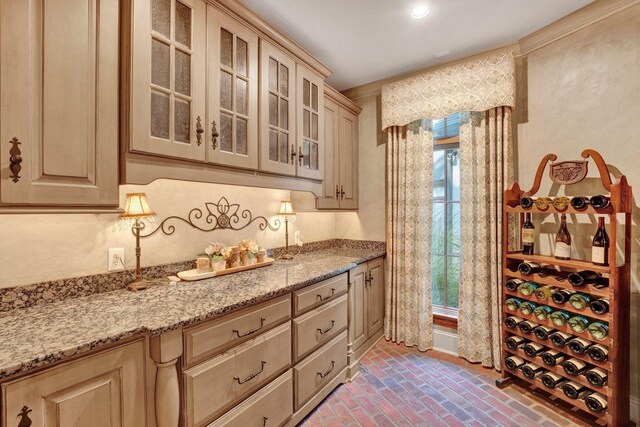 kitchen with light stone counters and light brown cabinetry