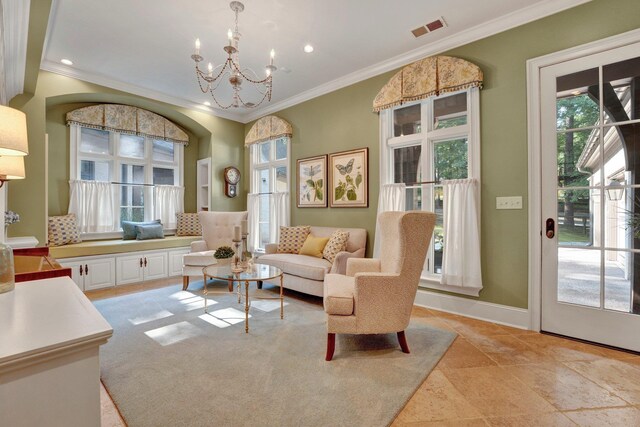 living room with a notable chandelier, light tile patterned flooring, and crown molding