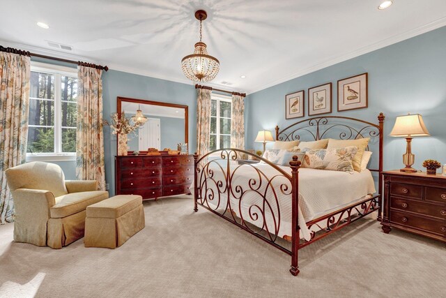 carpeted bedroom featuring ornamental molding and a chandelier