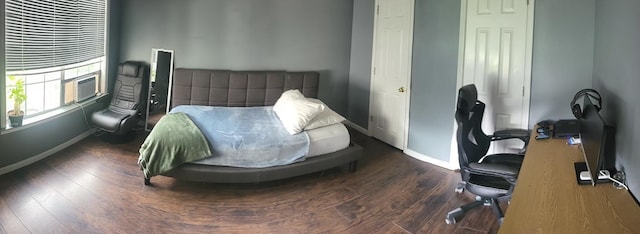 bedroom with dark wood-type flooring and cooling unit