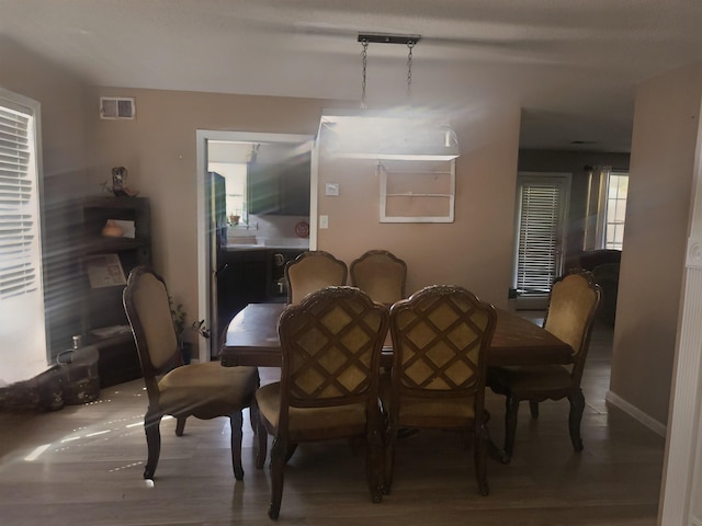 dining area with hardwood / wood-style flooring