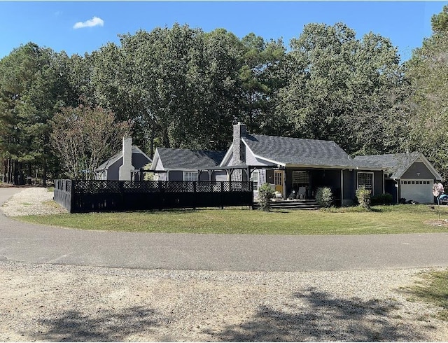 view of front of home with a front yard and fence