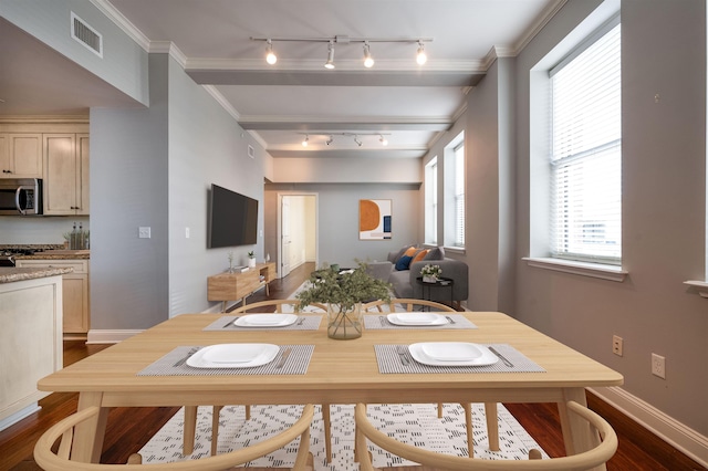 dining room with ornamental molding and dark hardwood / wood-style floors