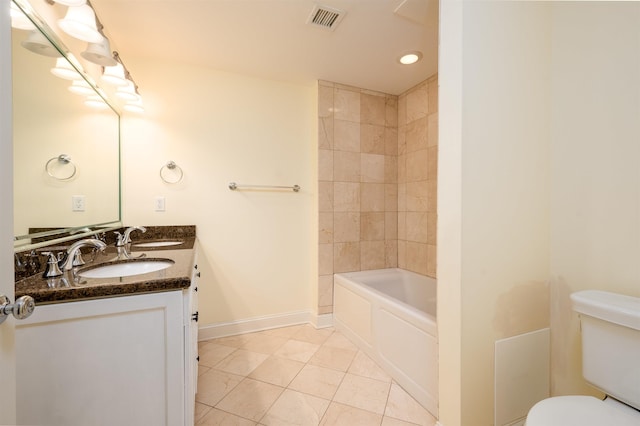 bathroom featuring vanity, tile patterned flooring, and toilet