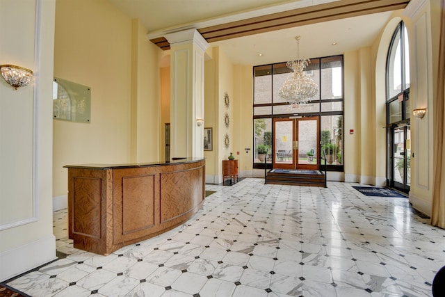 welcome area with decorative columns and a notable chandelier