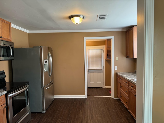 kitchen with light stone counters, appliances with stainless steel finishes, dark wood-type flooring, and ornamental molding