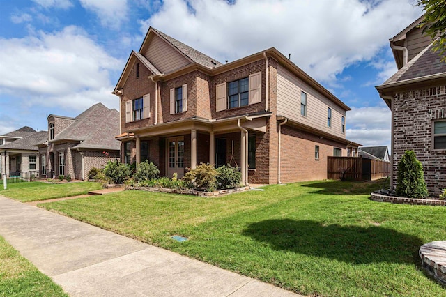 view of front of property with a front yard and covered porch