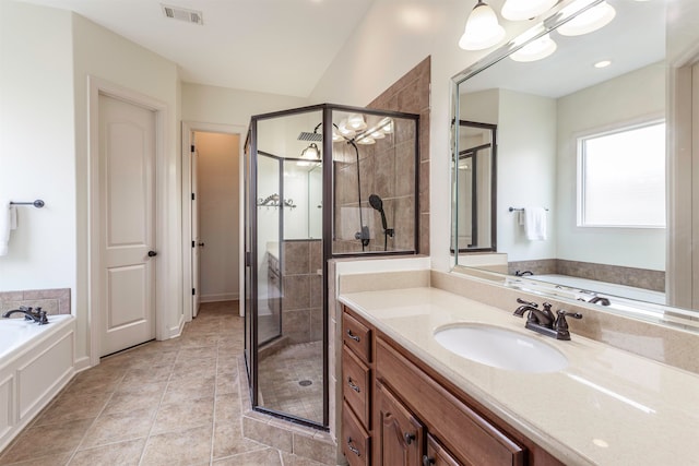 bathroom with shower with separate bathtub, tile patterned flooring, and vanity