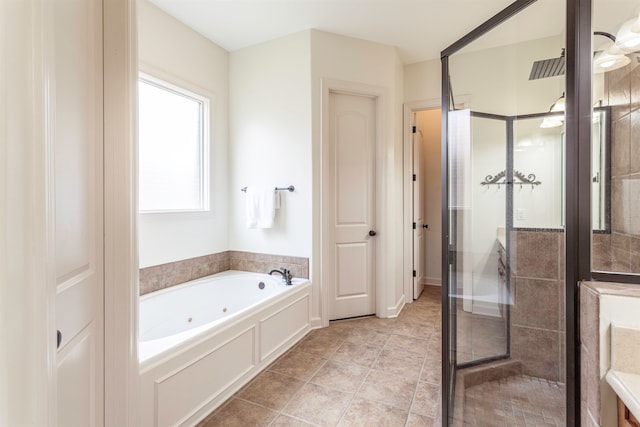 bathroom with independent shower and bath and tile patterned flooring