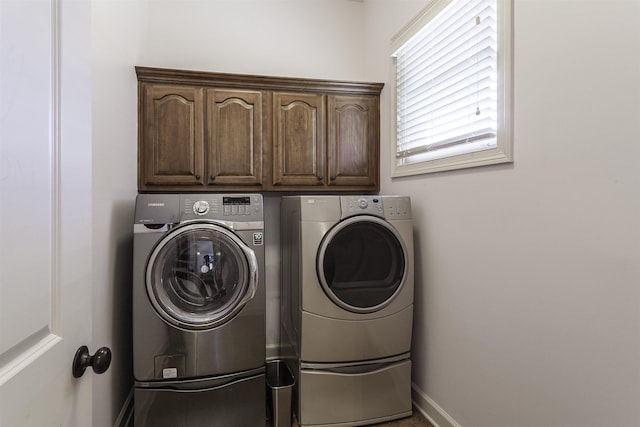 laundry area with cabinets and washer and dryer