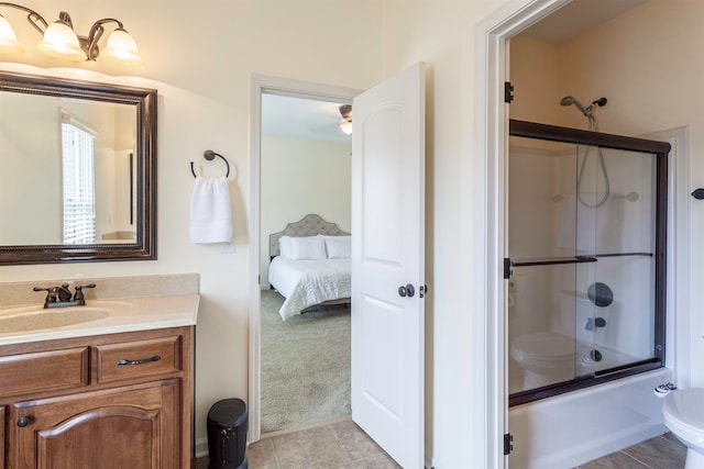 full bathroom with tile patterned flooring, enclosed tub / shower combo, vanity, and toilet