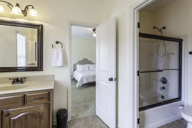 full bathroom featuring vanity, bath / shower combo with glass door, tile patterned floors, and toilet