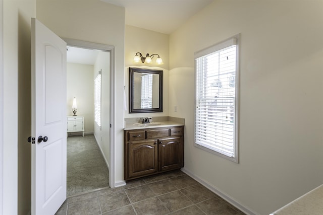 bathroom with vanity, a wealth of natural light, and tile patterned floors