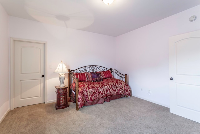 bedroom featuring light carpet