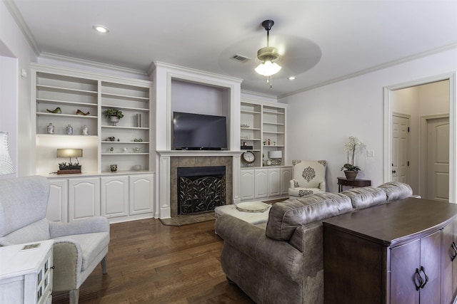 living room with a tile fireplace, ornamental molding, dark hardwood / wood-style floors, and ceiling fan