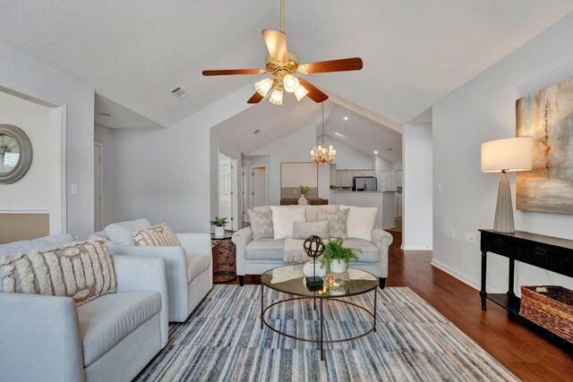 living room featuring lofted ceiling, hardwood / wood-style floors, a textured ceiling, and ceiling fan with notable chandelier