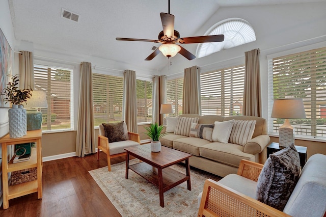 living room featuring vaulted ceiling, a wealth of natural light, dark hardwood / wood-style floors, and ceiling fan