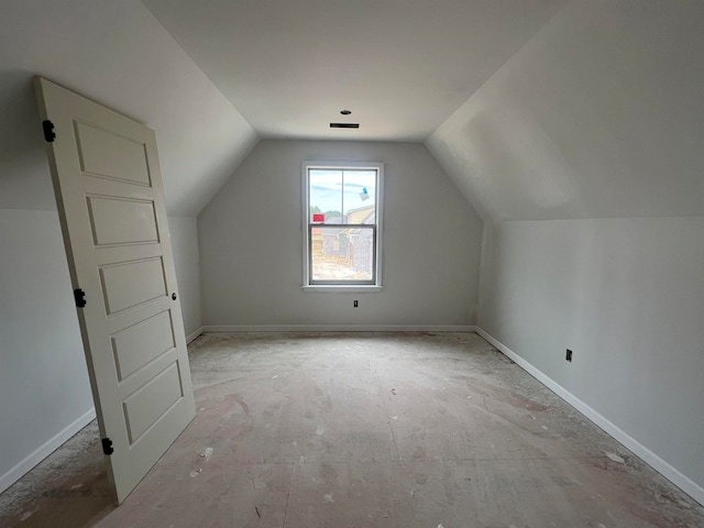 additional living space featuring lofted ceiling and baseboards