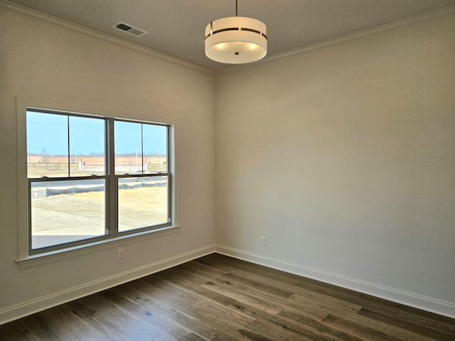 empty room with baseboards, crown molding, visible vents, and dark wood-style flooring