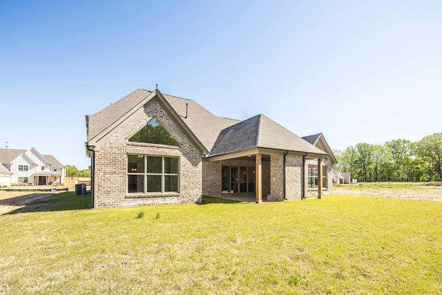 12103 Stromness Cv, Arlington, TN 38002 - back of house featuring brick siding, a lawn, and roof with shingles