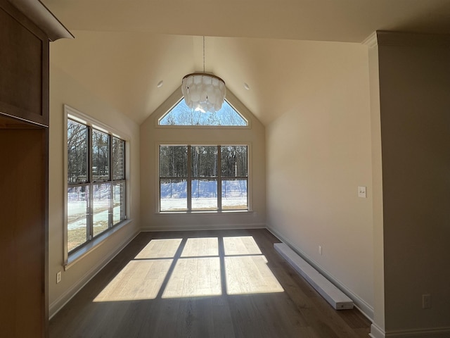 empty room featuring lofted ceiling, baseboards, a chandelier, and dark wood-type flooring