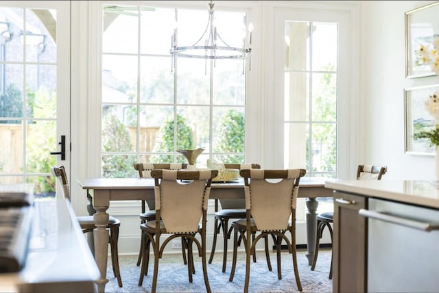 dining room with a healthy amount of sunlight and a chandelier