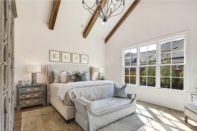 bedroom featuring beamed ceiling, a chandelier, high vaulted ceiling, and hardwood / wood-style flooring