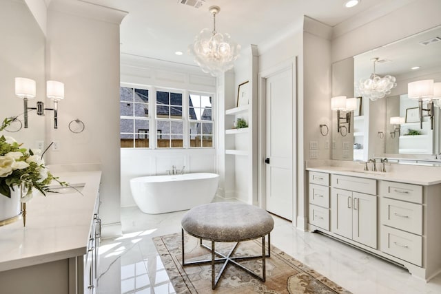 bathroom with vanity, ornamental molding, a washtub, and a notable chandelier