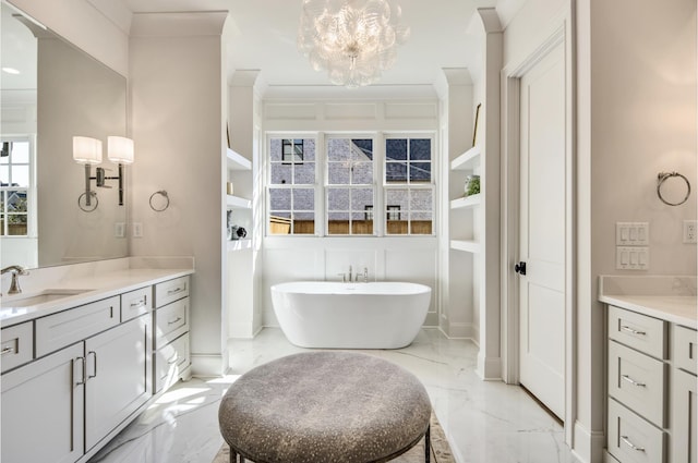 bathroom featuring ornamental molding, a bath, vanity, and an inviting chandelier