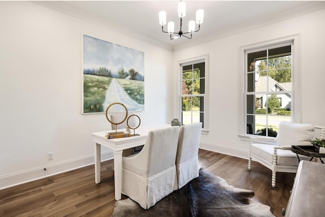 home office with dark hardwood / wood-style flooring, ornamental molding, and an inviting chandelier