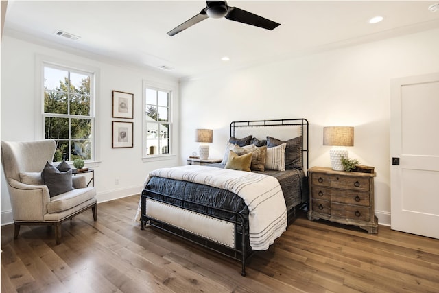 bedroom featuring crown molding, hardwood / wood-style floors, and ceiling fan