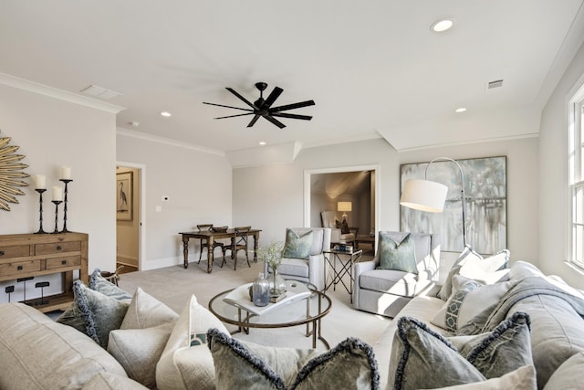 carpeted living room featuring crown molding and ceiling fan