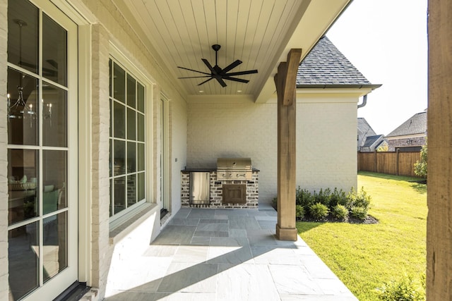 view of patio with ceiling fan, grilling area, and exterior kitchen