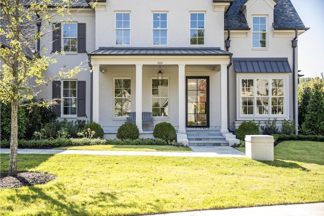 view of front of house featuring a front yard and covered porch